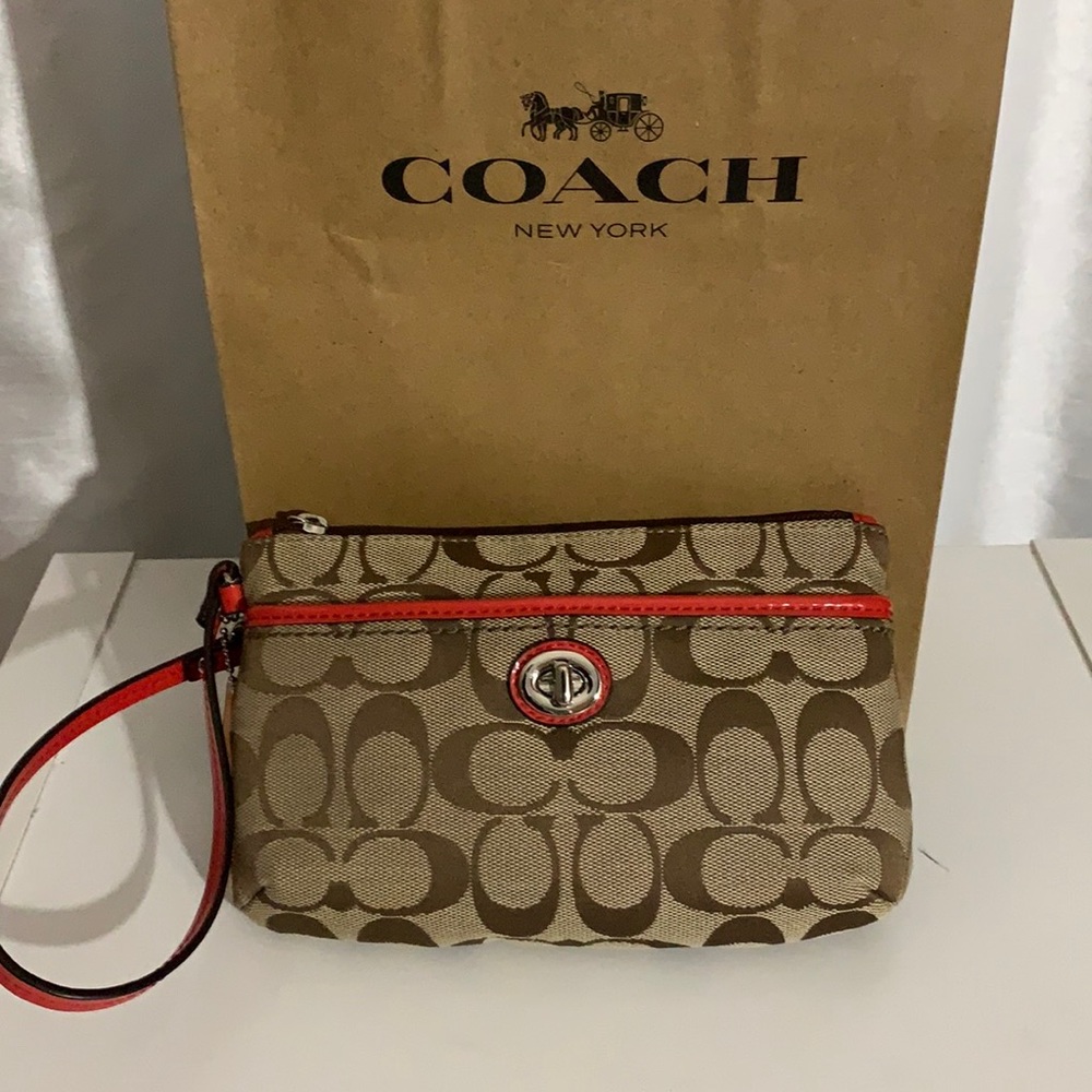 Coach wristlet with red patent leather trim